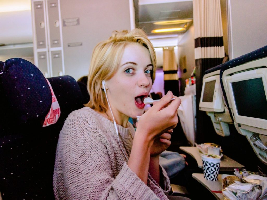 Safety Tips While Air Travel 3 woman eating yogurt on plane