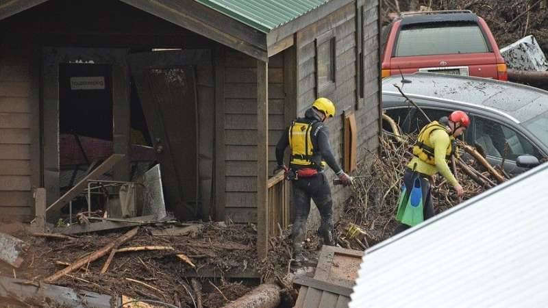 California flood sweeps cabins, cars down coastal canyon