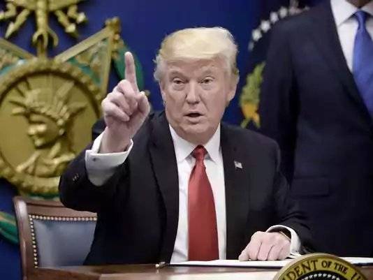 Trump attacks judge again on travel ban, Pence predicts victory in courts