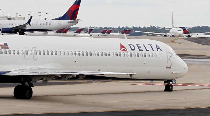 Unruly Delta passenger tried to open exit door in flight, complaint alleges
