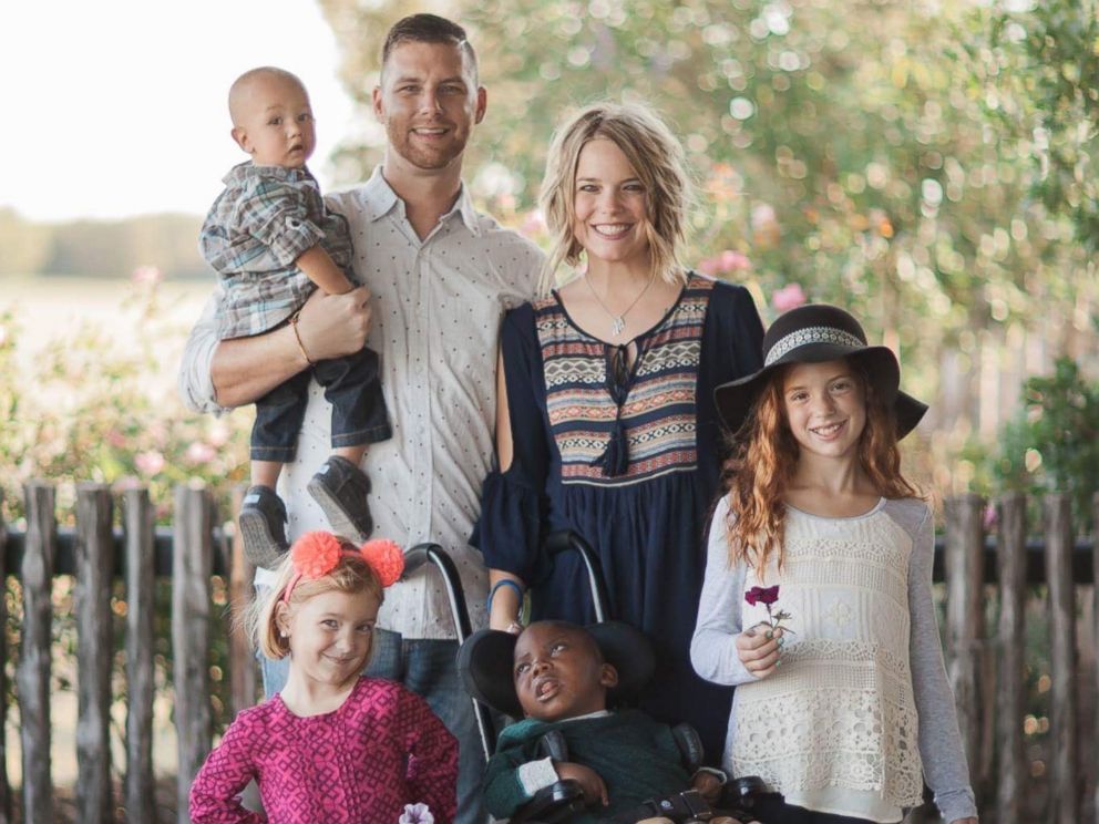 Parents surprise daughters by bringing home newly adopted sister