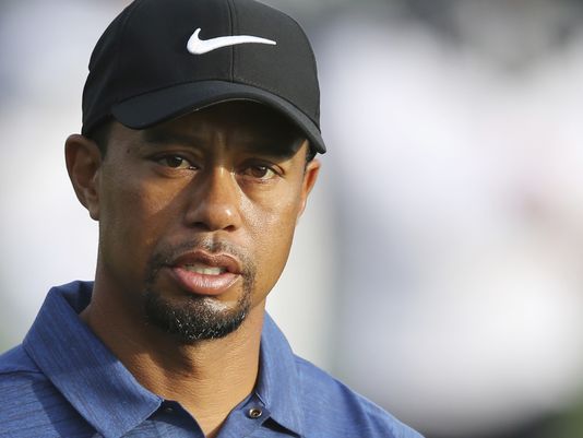 Woods back on the course in a cart, uncertain about future