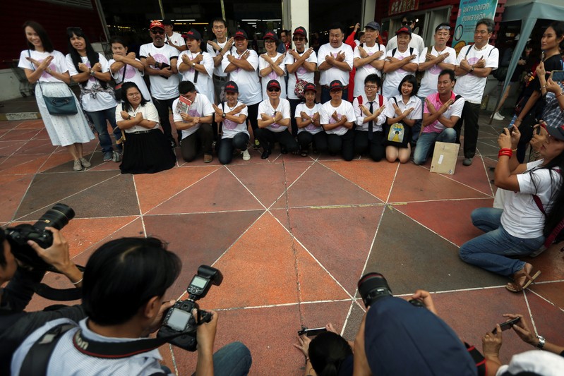 Thirty-five Thai activists report to police after junta protest