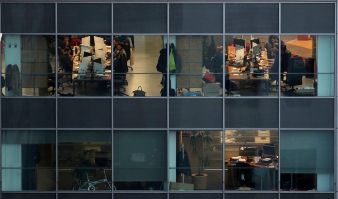 People work in offices in a building of Barcelona city Catalan corporate property market cools on political uncertainty