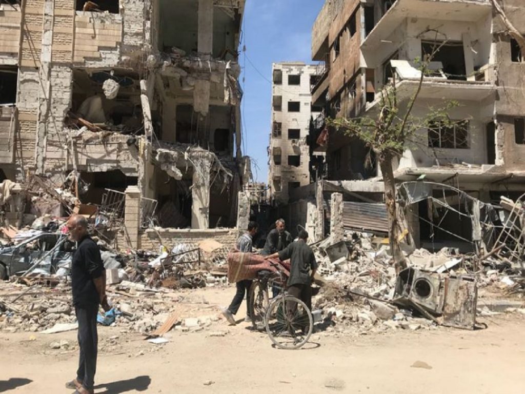 The Latest: Syrian TV: Air defense confront missiles in Homs