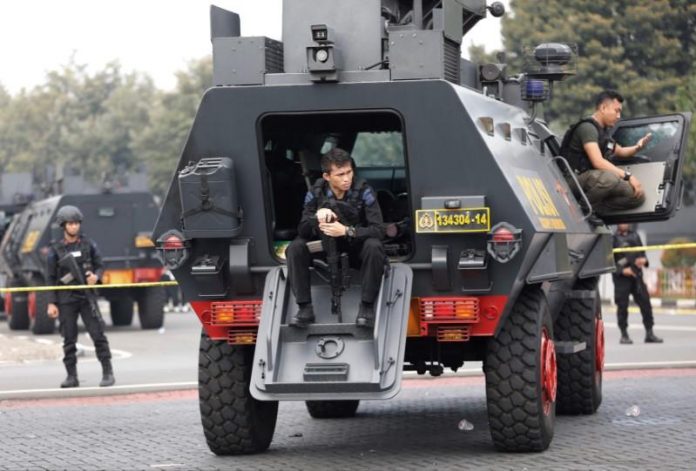 A mobile brigade policeman sits on an armoured personnel carrier inside the Mobile Police Brigade headquarters after a hostage crisis at a high-security jail located in the compound had been resolved in Depok, south of Jakarta Indonesia police say hostage crisis at high-security jail over