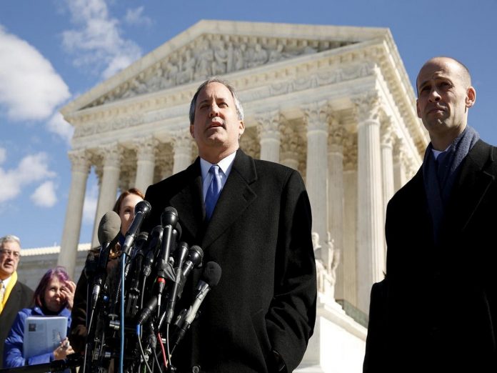 FILE PHOTO: Texas Attorney General Ken Paxton addresses reporters on the steps of the U.S. Supreme Court in Washington Texas sues Trump administration to end 'Dreamers' program, Politics News, Latest Politics News, Politics News Usa, Politics Live News, Top Politics News, Politics Live News Online
